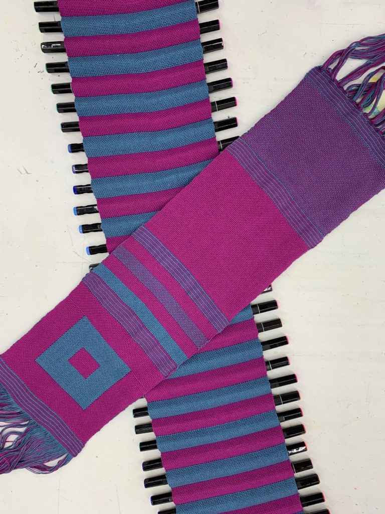 Examples of Anthony's double weave work in blue and pink striped and geometric patterns