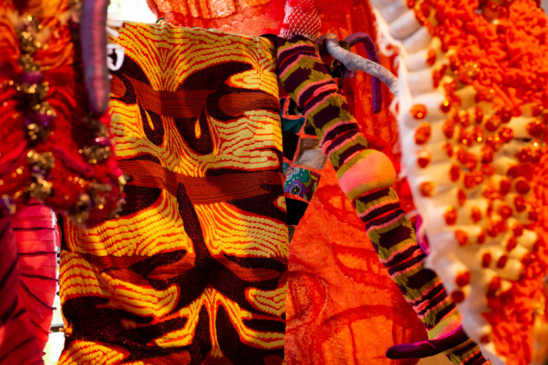 A close up of a plush textile sculpture showcasing multiple fabrics and patterns.