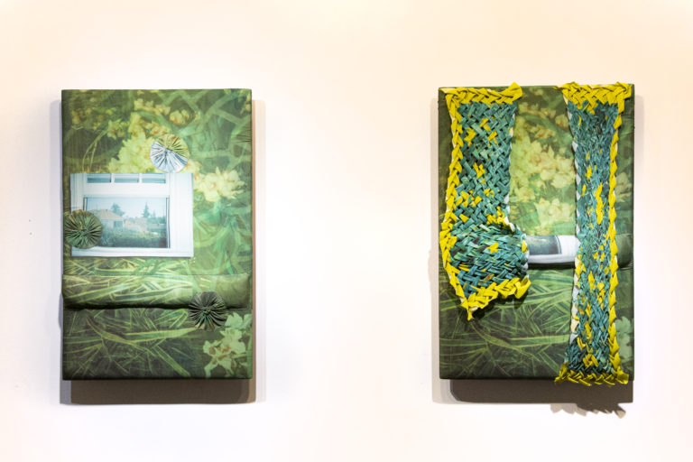 Two Green and yellow textile paintings on a white wall